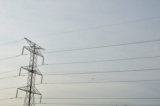 electricity poles against blue sky