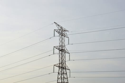 electricity poles against blue sky