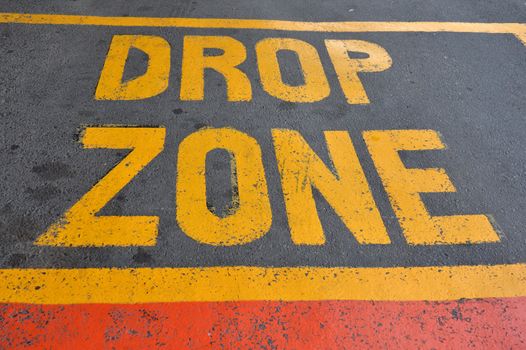 yellow drop zone text on the asphalt