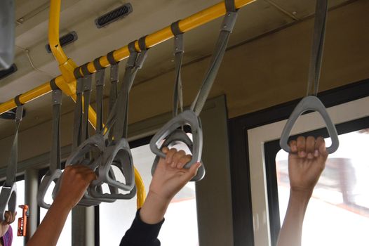 strap hangers on the bus