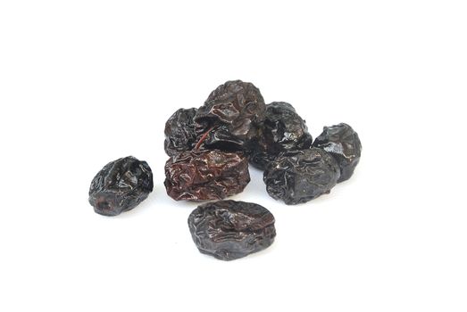 Black dried jujube on white background.