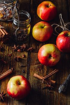 Red Apples with Scattered Clove, Cinnamon and Anise Star. Ingredients for Prepare Mulled Wine. Vertical Orientation.