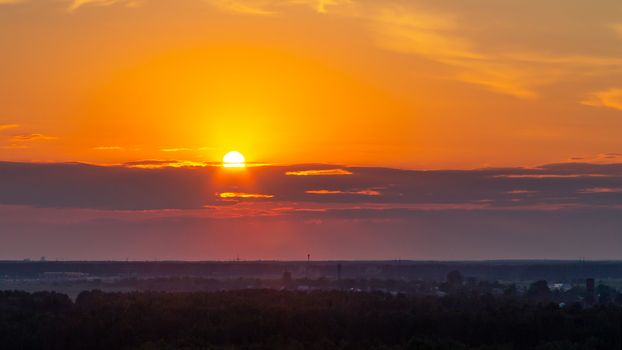 Panoramic view of the horizon and colorful sunset on the outskirts of the city.