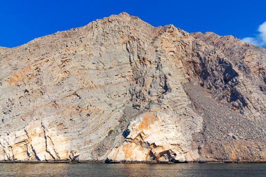 Sea and rocky shores in the fjords of the Gulf of Oman.