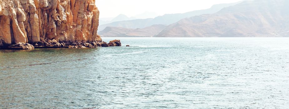 Sea and rocky shores in the fjords of the Gulf of Oman, panoramic view.