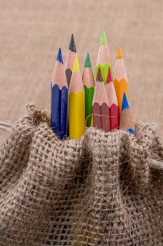 Color Pencils in a linen sack on canvas