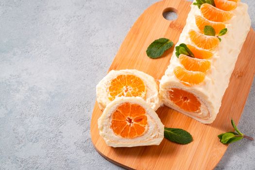 Sweet cake roll with whipped cream and tangerine filling.