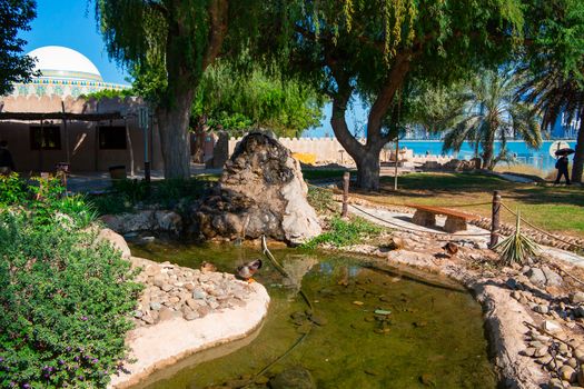 Decorative elements of urban improvement in the resort town - bed made of natural materials under a canopy, Heritage Village, Abu Dhabi.