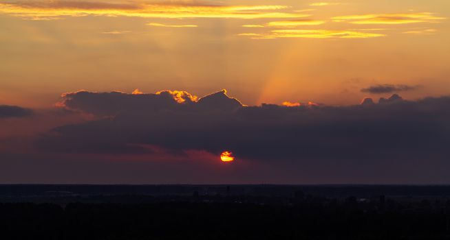 Panoramic view of the horizon and colorful sunset on the outskirts of the city.