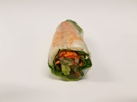 shrimp and lettuce and carrot rice paper roll on white desk or table