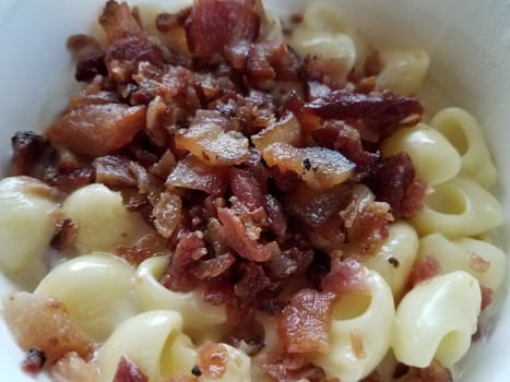 bacon meat pile and cheesy pasta shells in bowl