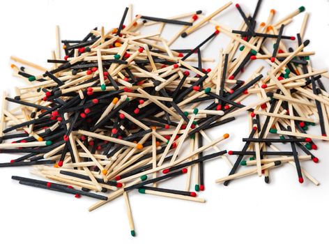 A lot of matches are mixed, of different color, isolated on white background