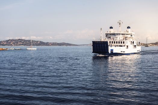 ferry sailing between two nearby islands, La Maddalena, Sardinia, Italy