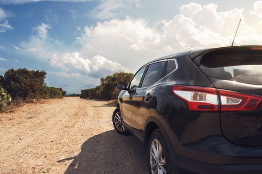 family car next to a dirt road, suv car background