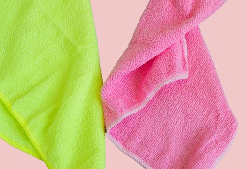 Microfiber cloths isolated on pink background, tools for cleaning and cleanliness. The concept of spring cleaning, flat lay.