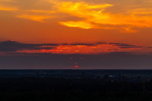 Panoramic view of the horizon and colorful sunset on the outskirts of the city.