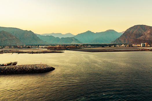 Sea coast of the Gulf of Oman, a small settlement or a town away on the shore.