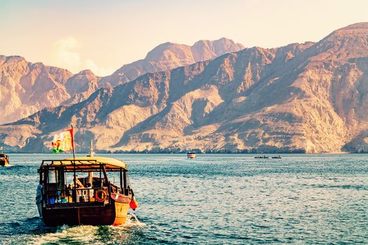 Sea, pleasure boats, rocky shores in the fjords of the Gulf of Oman.