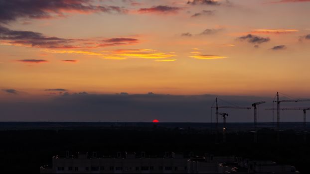 Panoramic view of the horizon and colorful sunset on the outskirts of the city.