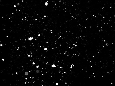 Texture of snow isolated on black background.