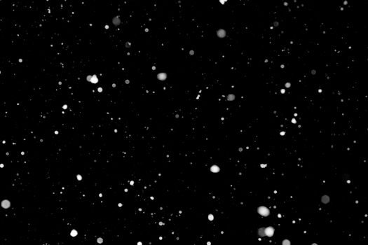 Texture of snow isolated on black background.