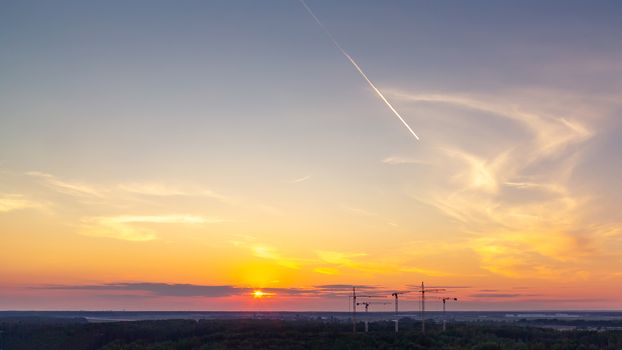 Panoramic view of the horizon and colorful sunset on the outskirts of the city.