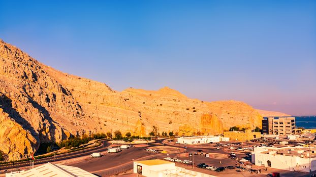 Sea coast of the Gulf of Oman, a small settlement or town on the shore.