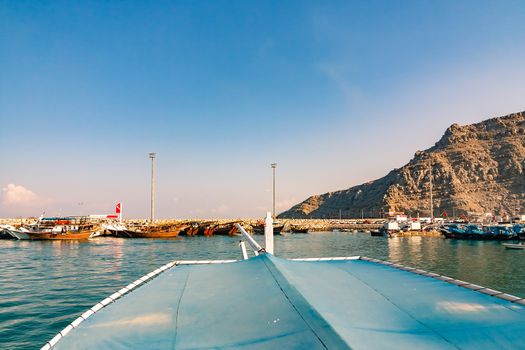 Sea, pleasure boats, rocky shores in the fjords of the Gulf of Oman.