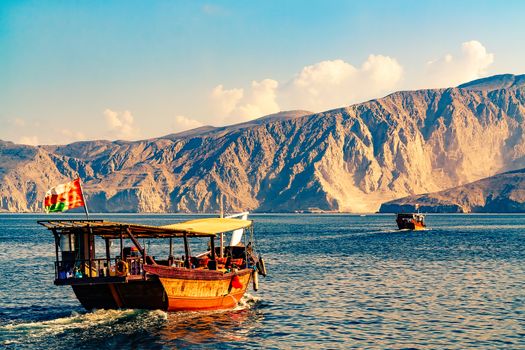 Sea, pleasure boats, rocky shores in the fjords of the Gulf of Oman.