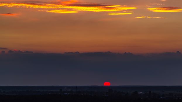 Panoramic view of the horizon and colorful sunset on the outskirts of the city.