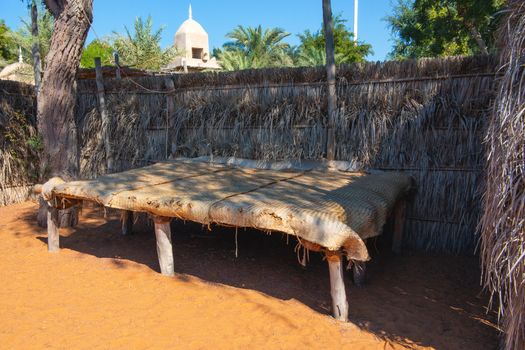 Decorative elements of urban improvement in the resort town - bed made of natural materials under a canopy, Heritage Village, Abu Dhabi.