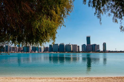 View of modern buildings from the canal shore in Abu Dhabi.