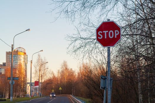 Stop sign on the side of the road at the entrance to the city.