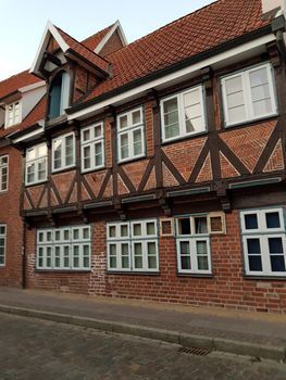 Half-timbered red brick houses near the river on the old harbor Lueneburg, Germany