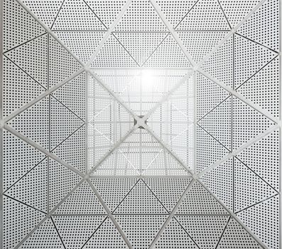 Modern metal ceiling dotted pattern. Sunlight entering the building from the top part of the roof.