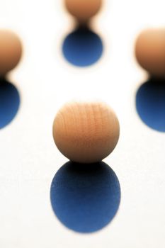 Abstract composition with few small wooden balls on light background
