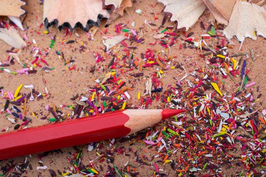 Red Color Pencil over some  pencil shavings