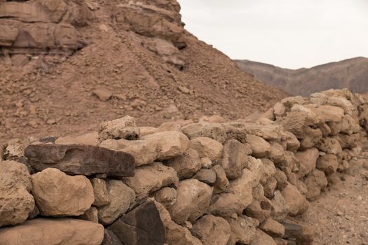 old stacked ancient original walls from stones in timna national park near eilat in israel
