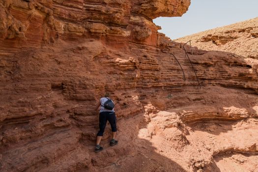 woman climbing in the red canyon in israel