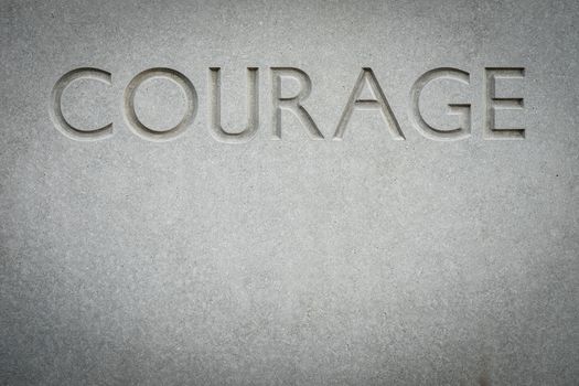 Conceptual Image Of The Word Courage Engraved Into Rock With Copy Space