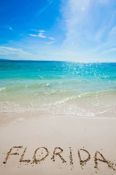 Turquoise water and golden sand with " florida " written on it