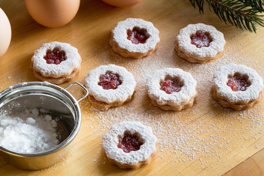 Traditional Linzer Christmas cookies dusted with sugar on a table