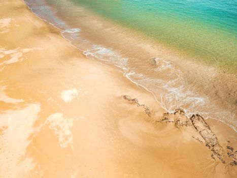 Beautiful Australian beach with turquoise waters and deep coloured sands showing patterning from tidal flows