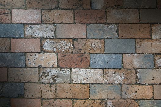 Multi-colored brick work texture lit diagonally