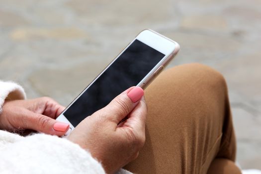 Young Girl Uses His Cell Phone To Check Your Electronic Mail.