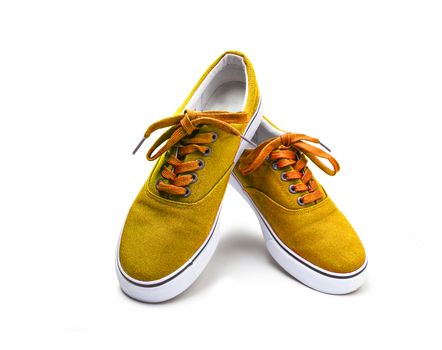 A pair of yellow color canvas shoes isolated on white background with clipping path