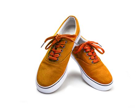 A pair of orange color canvas shoes isolated on white background with clipping path