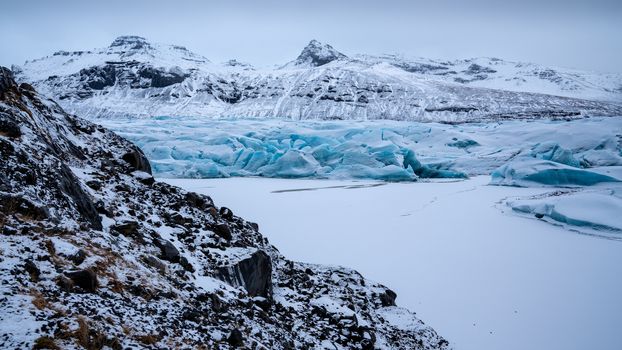 Panoramic image of the snow-coverd glacier Svinafellsjoekull on a winter day after snowfall, Iceland, Europe