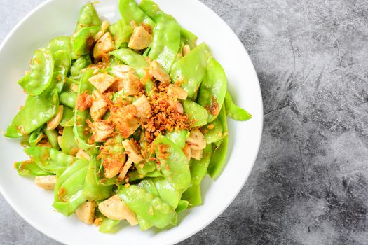 Stir Fry Snow Peas with Vietnamese Grilled Pork Sausage, topping with crispy fried shallots and garlics
