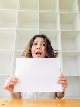 Attractive beautiful woman holding blank white paper.
